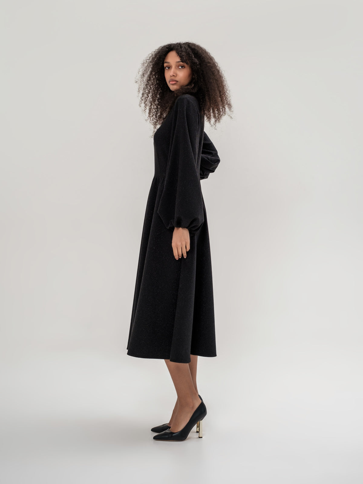 Black shiny thread midi dress with voluminous sleeves and a V-neck