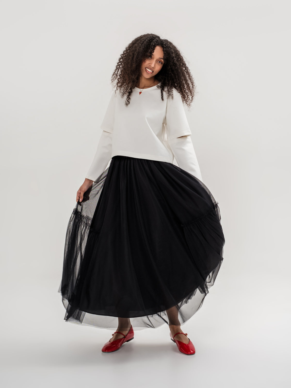 White top and black tulle lined skirt with elastic waist one size