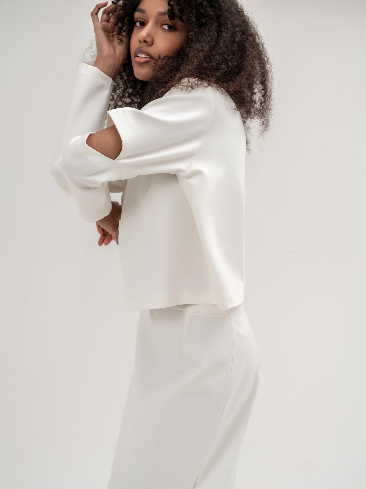 White top with slits in the elbow area 